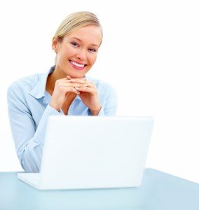 happy-young-woman-in-business-smiling-with-laptop